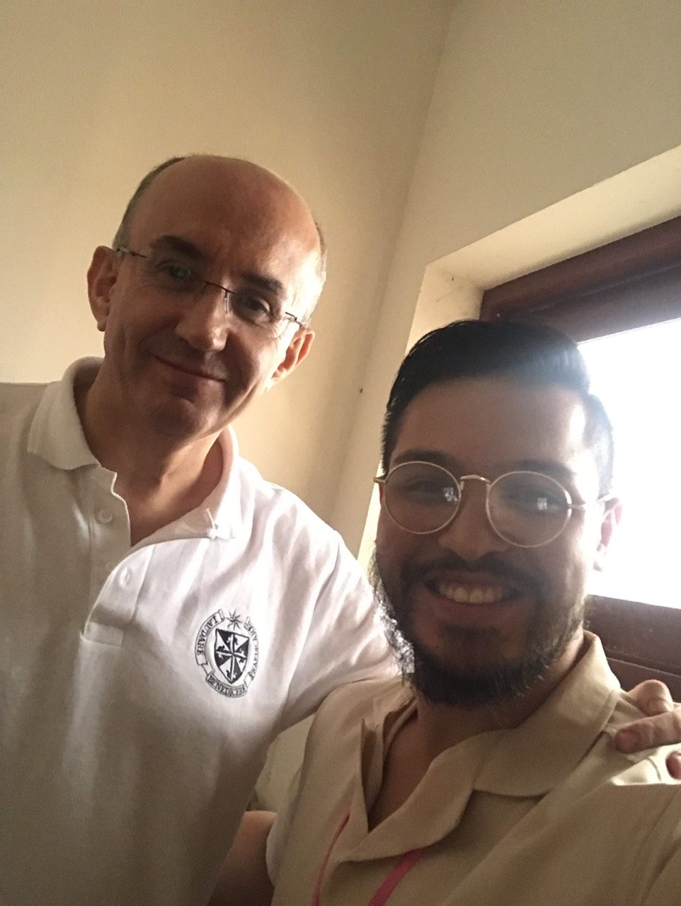 Selfie of Benz Rodil with a smiling chapter participant wearing a white polo shirt with the Dominican shield